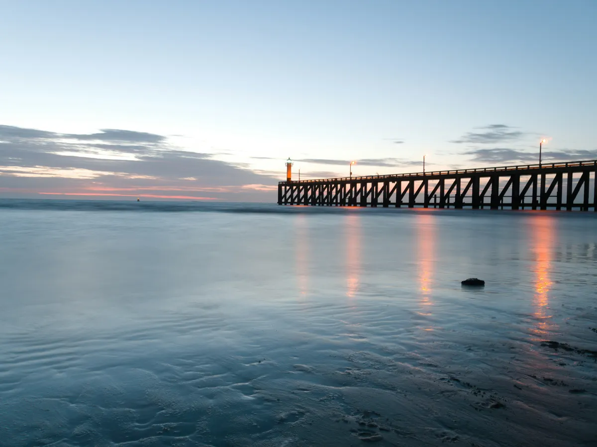Blankenberge pier at dusk with the Belgian North Sea coast, near the western dog beach area