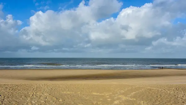 Sandy beach at Bredene with waves breaking on the shore