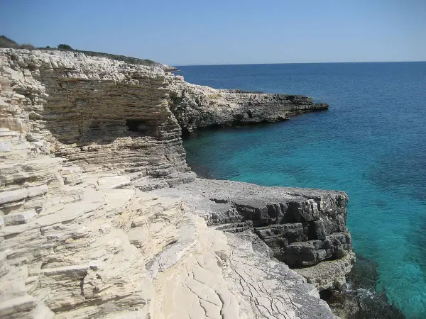 Turquoise waters along Cape Kamenjak coastline in Premantura, Croatia