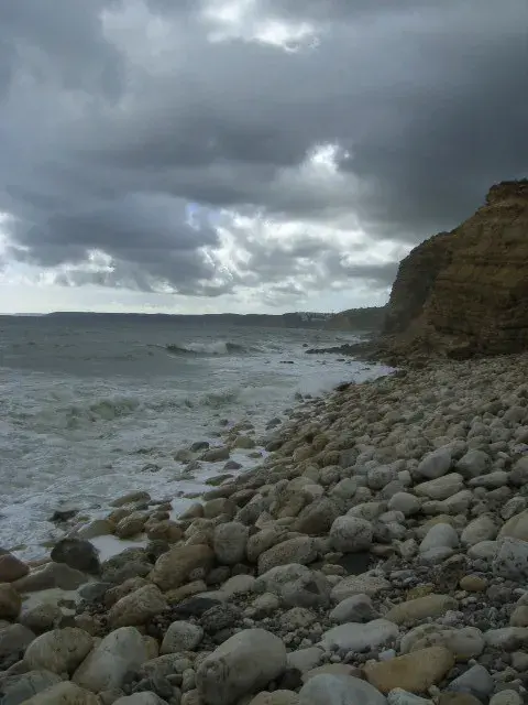 Praia da Boca do Rio beach with golden sand, dramatic cliffs and Roman ruins near Budens, Algarve