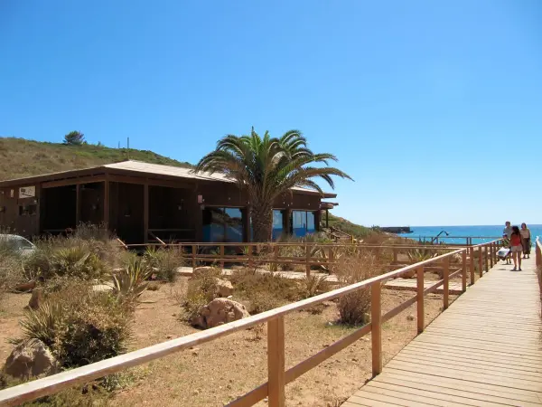 Praia da Boca do Rio beach with golden sand, dramatic cliffs and Roman ruins near Budens, Algarve