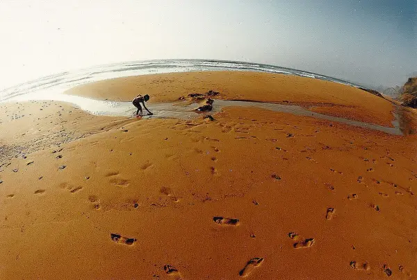 Praia da Ponta Ruiva with its distinctive red sandstone cliff and golden sand, near Sagres, Algarve
