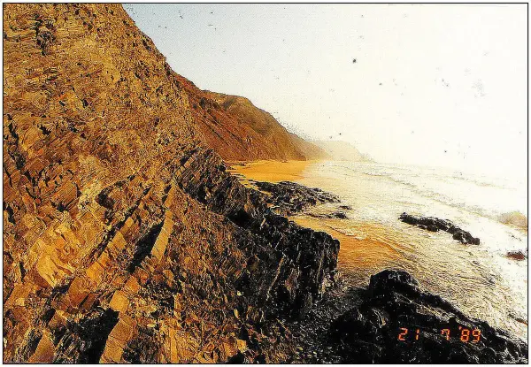 Praia da Ponta Ruiva with its distinctive red sandstone cliff and golden sand, near Sagres, Algarve