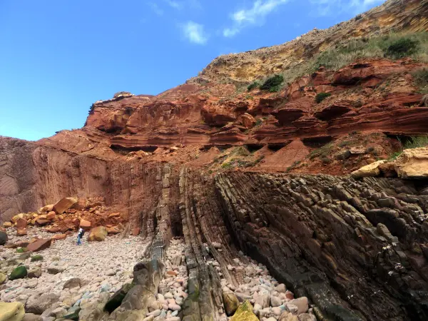 Praia da Ponta Ruiva with its distinctive red sandstone cliff and golden sand, near Sagres, Algarve