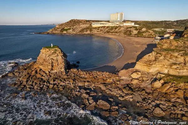 Praia das Amoeiras dog beach with traditional palheiro shelters in Santa Cruz, Torres Vedras