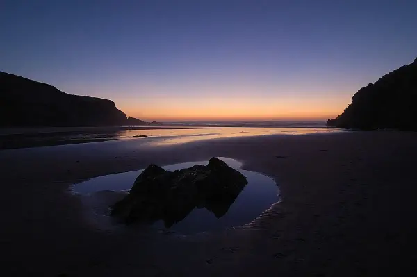 Praia do Brejo Largo wild golden sand beach with dramatic cliffs on the Alentejo coast