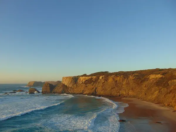 Praia do Brejo Largo wild golden sand beach with dramatic cliffs on the Alentejo coast